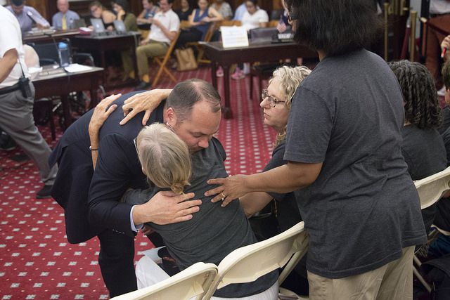 City Council Speaker Corey Johnson hugs a safe streets advocate on Tuesday during an emergency Transportation Committee hearing on speed cameras.